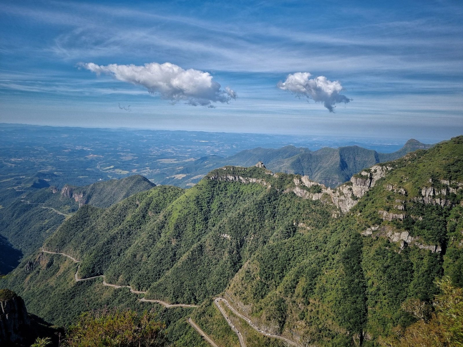 A stunning panorama of the winding roads and lush hills of Serra do Rio do Rastro in Santa Catarina, Brazil.
